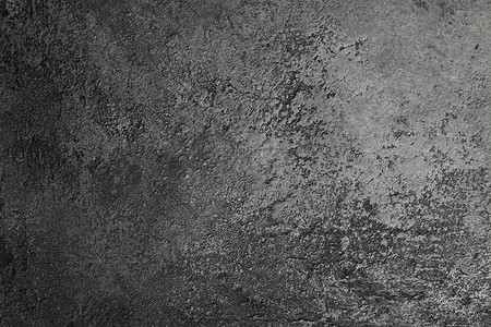 磨损摄影照片_复古石料混凝土深灰色背景与旧的废弃磨损和黑色飞溅。柔和的油漆质感的地面或墙体水泥质感的磨擦风格。案文的篇幅