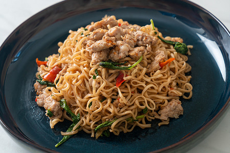 homemade stir-fried instant noodles with Thai basil and minced pork - Thai food style