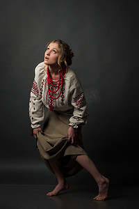 侗族刺绣摄影照片_在乌克兰刺绣谨慎步骤，望着相当穷受惊的女孩