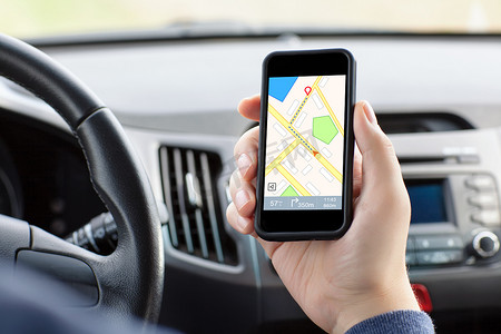 man sitting in the car and holding a phone with interface naviga