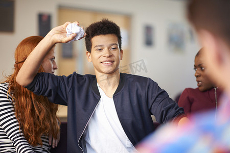 男学生在公共休息室扔皱巴巴的纸