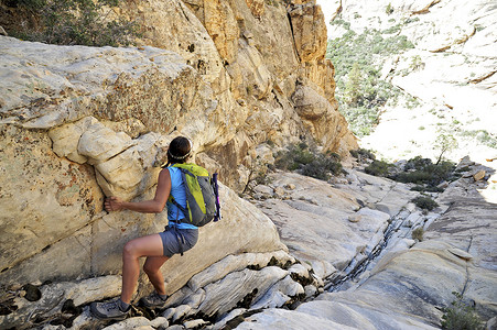 攀岩女摄影照片_美国内华达州威尔逊山年轻的女攀岩者爬上陡峭的裂缝