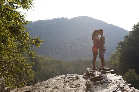 美国宾夕法尼亚州汉堡年轻夫妇在岩壁上接吻
