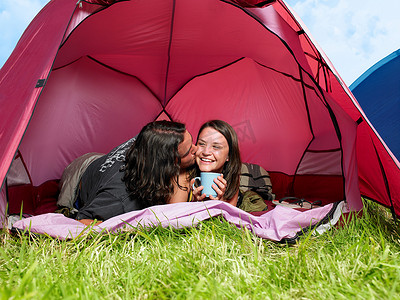 vi贴图咖啡杯摄影照片_一对情侣在粉色帐篷里接吻