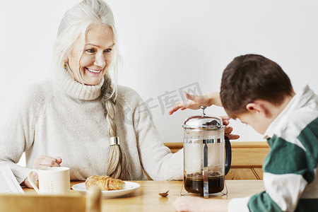 咖啡壶摄影照片_祖母和孙子在咖啡馆里煮咖啡