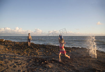 美国佛罗里达州朱庇特岛从溅起的海浪中逃脱的女孩吹石保护区