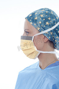 戴着手术帽和口罩的外科医生看向别处