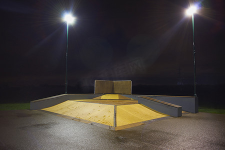 溜冰公园摄影照片_夜间的坡道结构和滑板公园