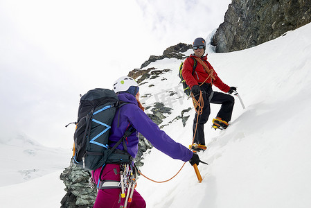 瑞士萨斯菲登山者攀登白雪覆盖的山峰