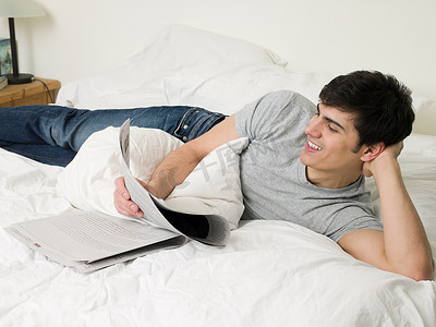男人在床上看报纸