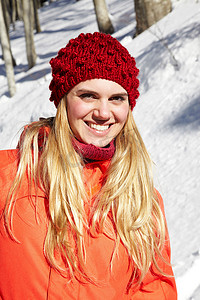 温度和人摄影照片_戴着红色针织帽子和外套的妇女肖像