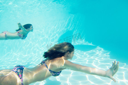 比基尼美女欧美摄影照片_穿着比基尼的女子在游泳池里游泳