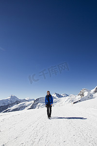男性徒步旅行者在积雪覆盖的风景中徒步旅行瑞士格林德尔瓦尔德的