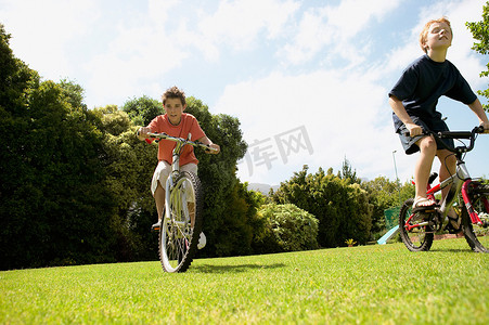 小男孩们在公园里骑车
