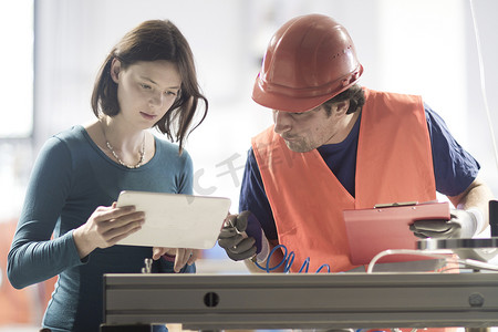 工业职业中使用数字平板电脑的男性和女性同事
