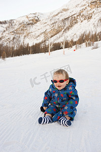 坐在雪地里的男婴肖像
