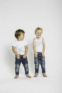 可爱纯色摄影照片_工作室里两个手插口袋的可爱男孩的肖像
