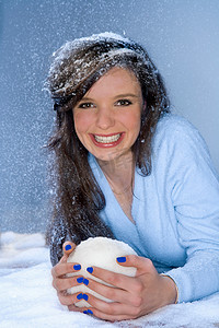 滚雪球摄影照片_年轻女子肖像手持滚雪球