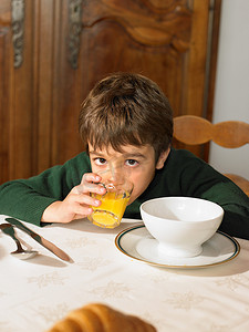休息时喝橙汁的男孩