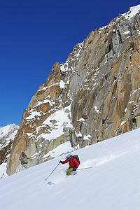 男子滑雪运动员在法国格拉尼亚阿尔卑斯山的勃朗峰上加速下坡