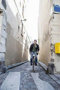 法国巴黎一名中年男子在狭窄的鹅卵石路上骑车