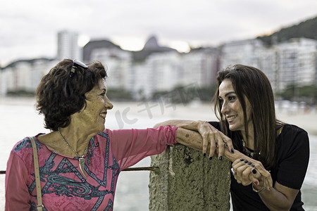 千万豪礼摄影照片_巴西里约热内卢科帕卡巴纳海滩一名成熟女子牵着母亲的手