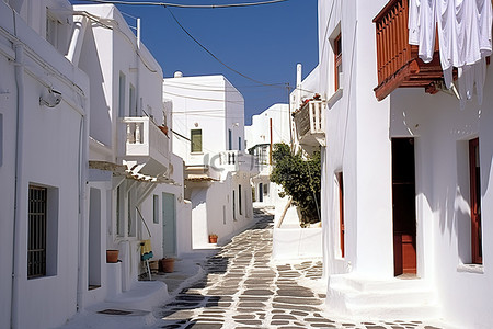 狭窄背景图片_一条白色的狭窄街道，两旁都是白色的建筑