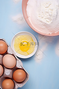纸盒中的鸡蛋香草精蛋黄和粉红色的面粉