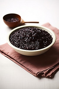 乌龙黑米茶背景图片_黑米被放在一个白色的碗里