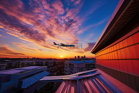 仁川国际机场背景图片_日落时一架飞机飞越建筑物
