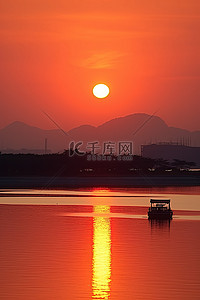 太阳从池塘里的小船后面升起