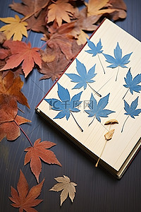 一些飘动的秋叶和一本蓝色的书