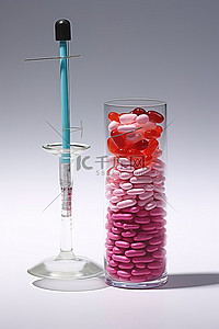 药丸背景图片_一个装有药丸的注射器和旁边的一个玻璃杯