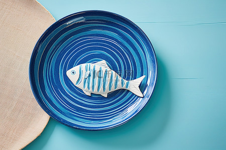 蓝色盘子背景图片_蓝色盘子上的蓝色鱼盘