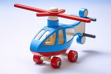 直升机背景图片_带有红色和蓝色尾巴和轮子的玩具直升机