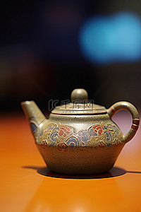 彩色背景中的桌子上放着一个旧茶壶