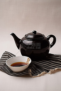 条纹桌布背景图片_条纹桌布上的黑色茶壶