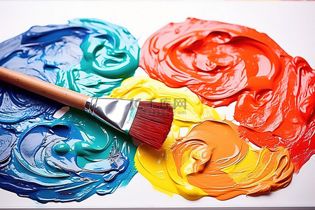 油画刷子背景图片_一个调色板，上面有彩色颜料和一把画笔