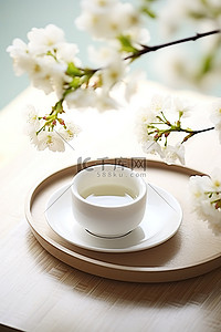白枝条背景图片_桌上放着一个白盘子和一杯茶