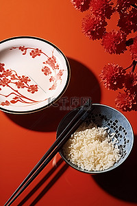 餐具筷子背景图片_桌子上碗里的筷子和米饭，旁边是印花红色
