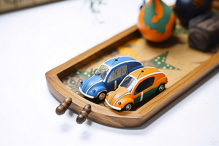 橙色的汽车背景图片_木托盘顶部有两个蓝色和橙色的汽车玩具
