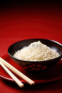 米饭盛在碗里，筷子放在红盘上