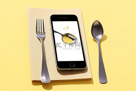 iphone三视图背景图片_叉子和勺子旁边放着一部 iPhone