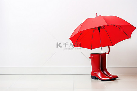 白色地板上的红色靴子和雨伞