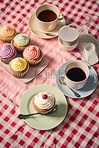 奶茶店招牌背景图片_桌面上放着一杯茶和几个纸杯蛋糕