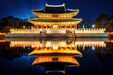 池塘景观背景图片_夜晚河边一座优雅的韩国宫殿