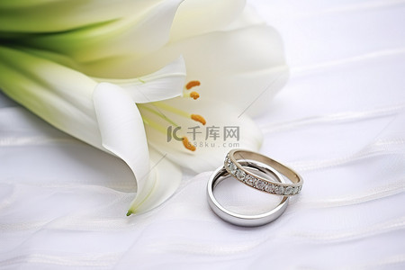 纯真背景背景图片_联系莉莉与结婚戒指和丝带与花边背景