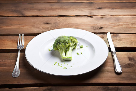 菜食物背景图片_木凳上放着一个空盘子，上面有生菜和西兰花