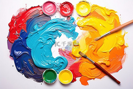 油画刷子背景图片_一个调色板，上面有彩色颜料和一把画笔