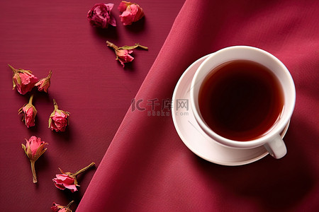 鲜果枸杞背景图片_一杯茶放在一块粉红色的布上